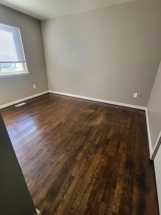 spare room featuring dark hardwood / wood-style flooring