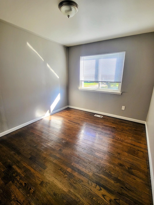 spare room featuring dark hardwood / wood-style flooring