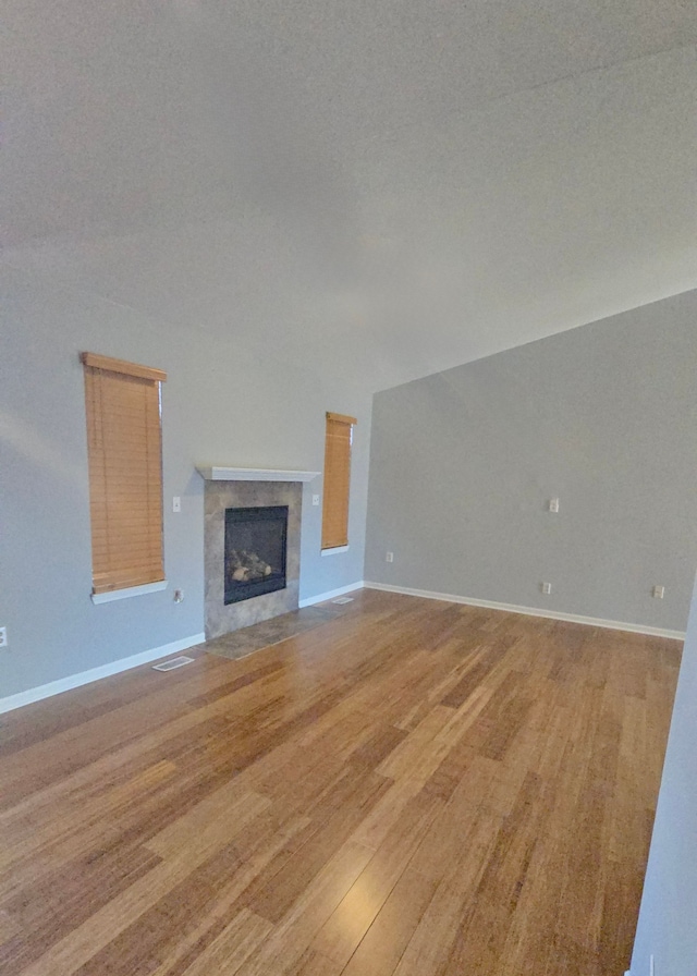 unfurnished living room with light hardwood / wood-style floors and a fireplace