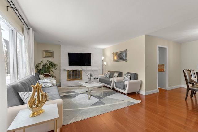 living room featuring wood-type flooring and a fireplace