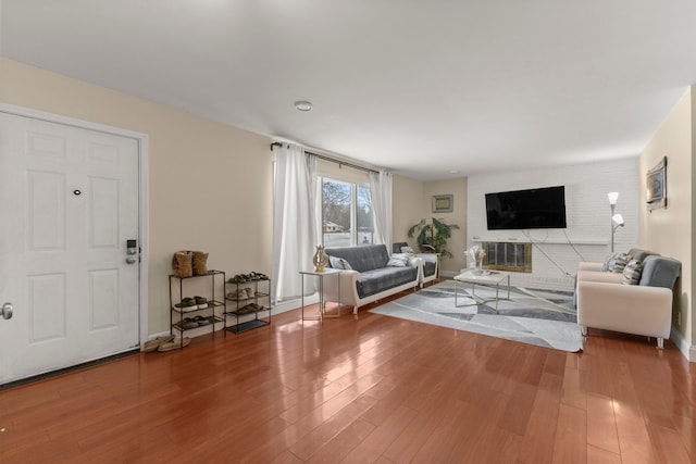 living room featuring a fireplace and wood-type flooring