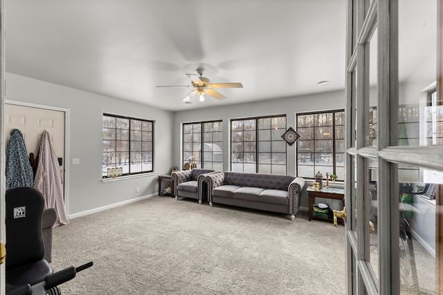 living room with ceiling fan and carpet floors