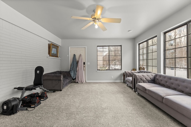 carpeted living room with ceiling fan