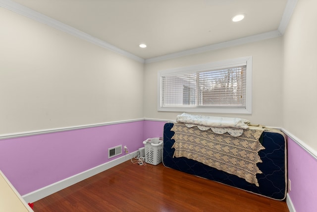 bedroom with hardwood / wood-style flooring and ornamental molding