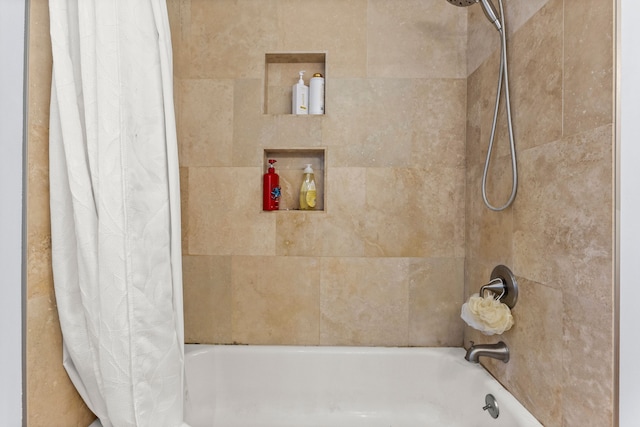 bathroom featuring shower / bathtub combination with curtain