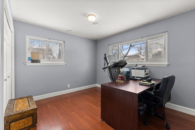 office featuring dark wood-type flooring and a healthy amount of sunlight