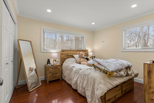 bedroom with dark hardwood / wood-style flooring, multiple windows, and a closet