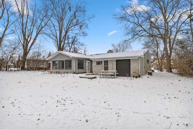 snow covered house with a sunroom