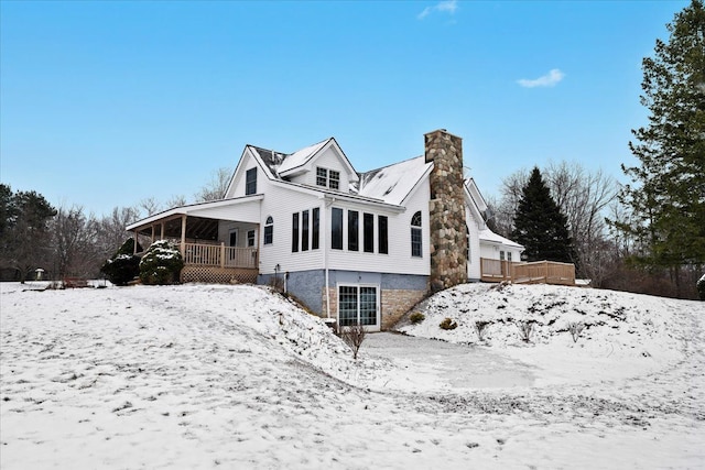 snow covered property with a deck