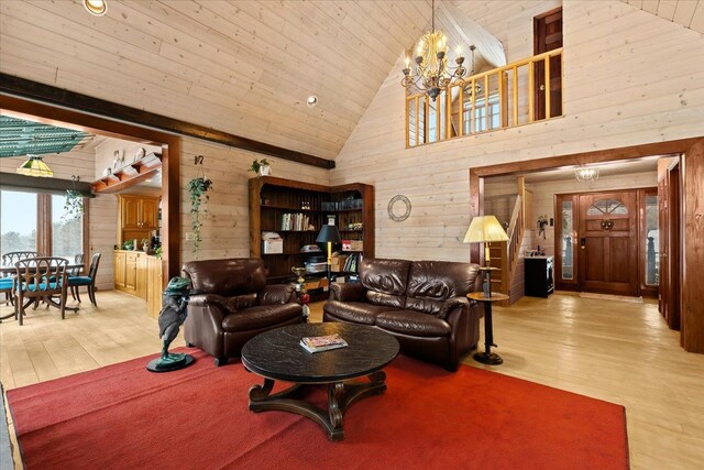 living room featuring high vaulted ceiling, wood walls, wood ceiling, and light wood-type flooring