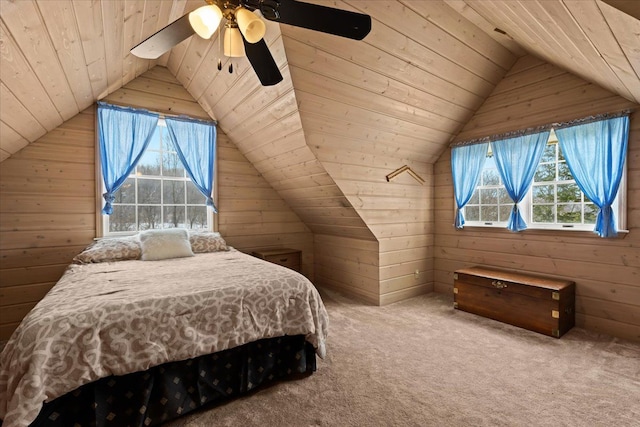 bedroom with ceiling fan, wooden ceiling, carpet flooring, and wood walls