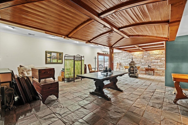 recreation room featuring lofted ceiling, wood ceiling, and a wood stove