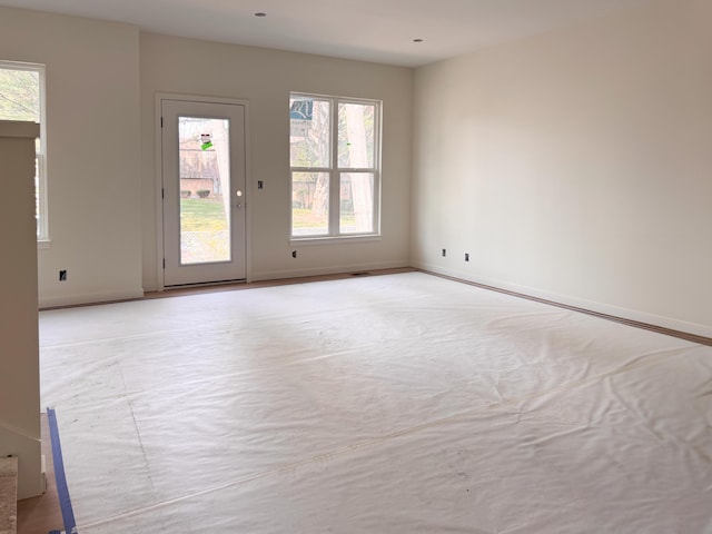 unfurnished room featuring baseboards