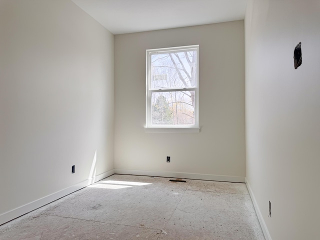 spare room featuring baseboards and visible vents