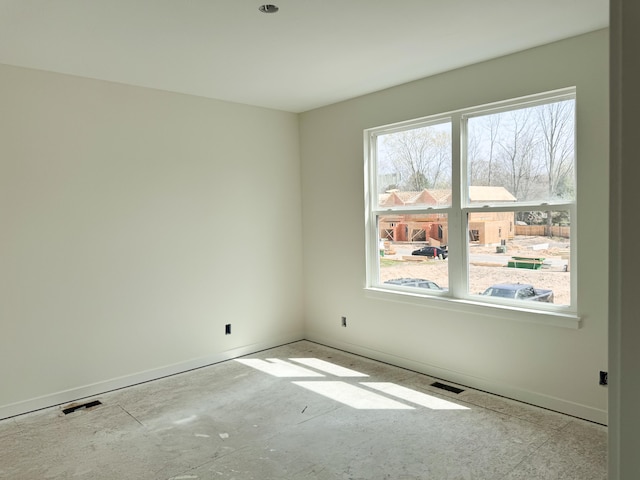 empty room with baseboards and visible vents