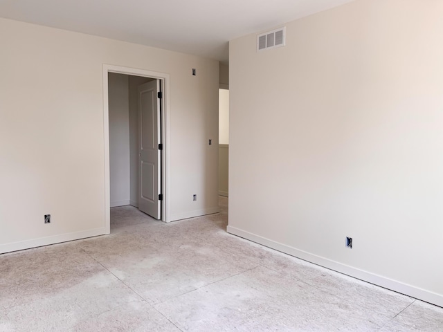unfurnished room featuring visible vents, concrete flooring, and baseboards