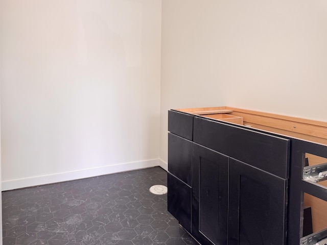 bathroom with tile patterned floors and baseboards