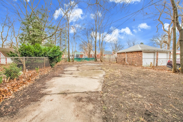 view of yard with a garage and an outdoor structure