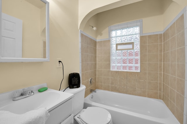 full bathroom with vanity, tiled shower / bath combo, and toilet