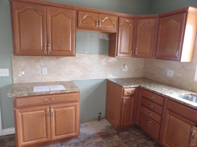 kitchen with light stone countertops and backsplash