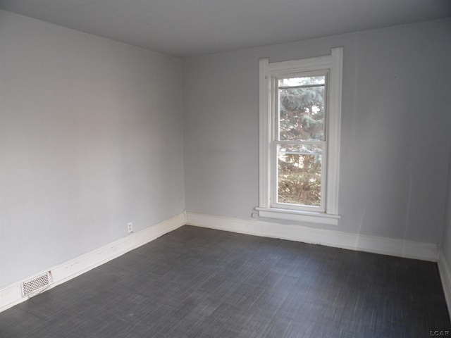 unfurnished room featuring dark hardwood / wood-style floors