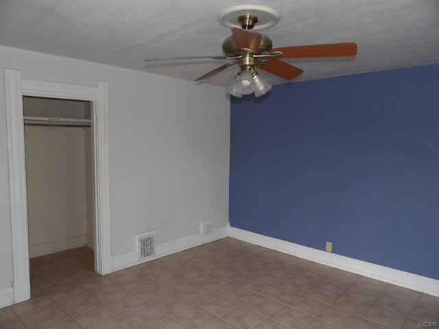 unfurnished bedroom with ceiling fan, a closet, and a textured ceiling