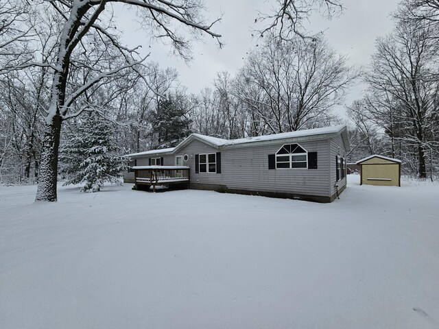 6493 White Rd, Muskegon, MI 49442 - view of front facade featuring a deck, a garage, and an outdoor structure