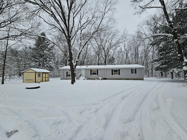 view of front of property with a garage and an outbuilding