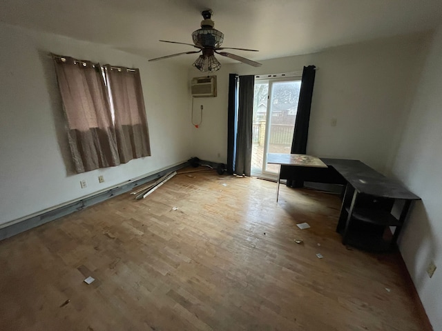 empty room featuring a wall unit AC, ceiling fan, and wood-type flooring