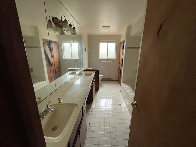 full bathroom featuring tile patterned floors, vanity, toilet, and bathtub / shower combination