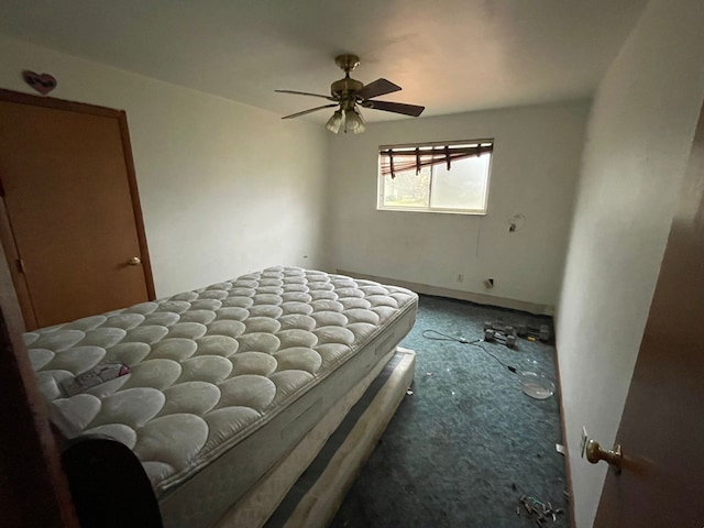 unfurnished bedroom featuring ceiling fan and dark colored carpet