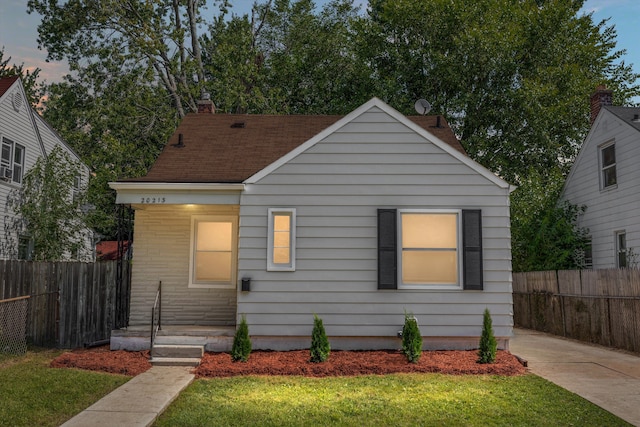 bungalow-style house with a lawn