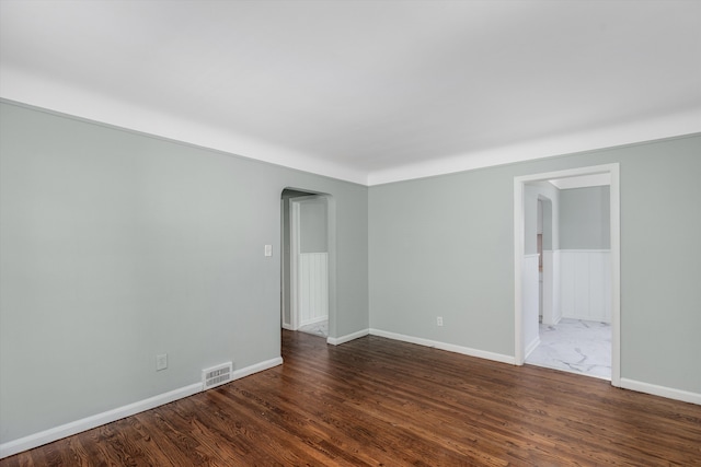 spare room with dark wood-type flooring