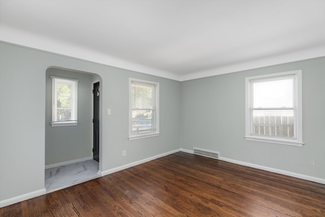unfurnished room featuring dark hardwood / wood-style flooring