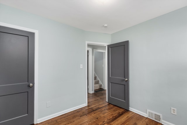 unfurnished bedroom featuring dark hardwood / wood-style floors