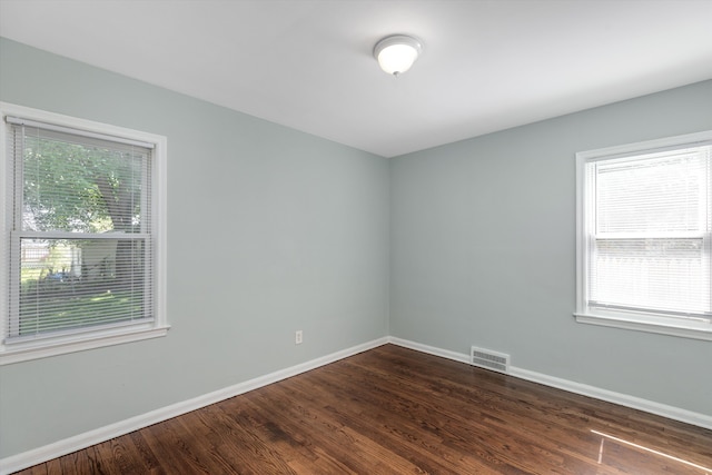 spare room with dark hardwood / wood-style flooring