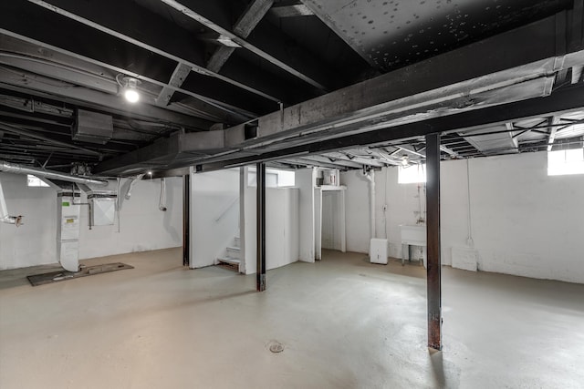basement with gas water heater and sink