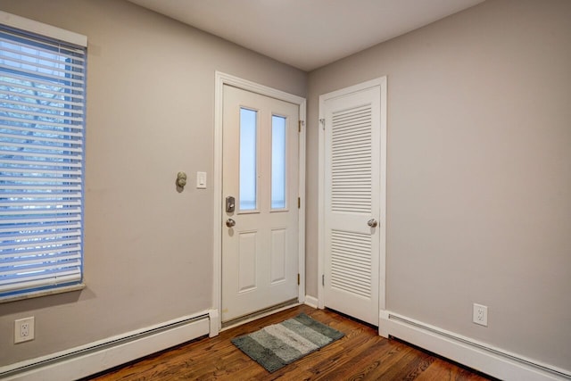 foyer entrance featuring dark hardwood / wood-style flooring and a baseboard radiator