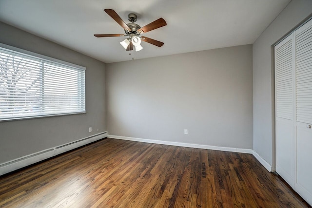 unfurnished bedroom featuring a closet, ceiling fan, dark hardwood / wood-style flooring, and a baseboard heating unit