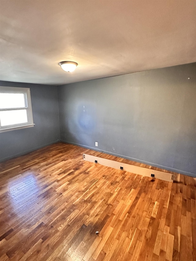 unfurnished room featuring hardwood / wood-style flooring