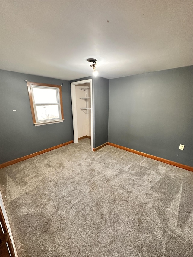 unfurnished bedroom featuring carpet flooring and a closet