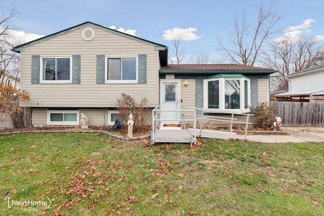 tri-level home with a front yard