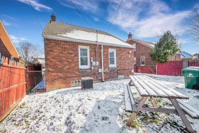 snow covered property featuring cooling unit