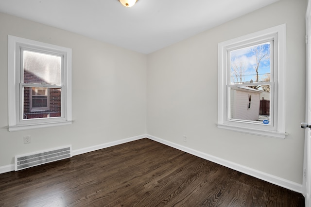 unfurnished room with dark hardwood / wood-style flooring