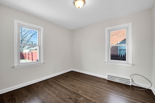 unfurnished room featuring dark wood-type flooring