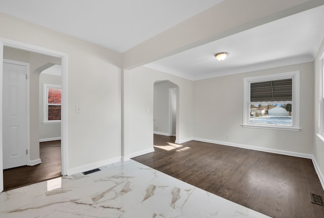 unfurnished room with wood-type flooring