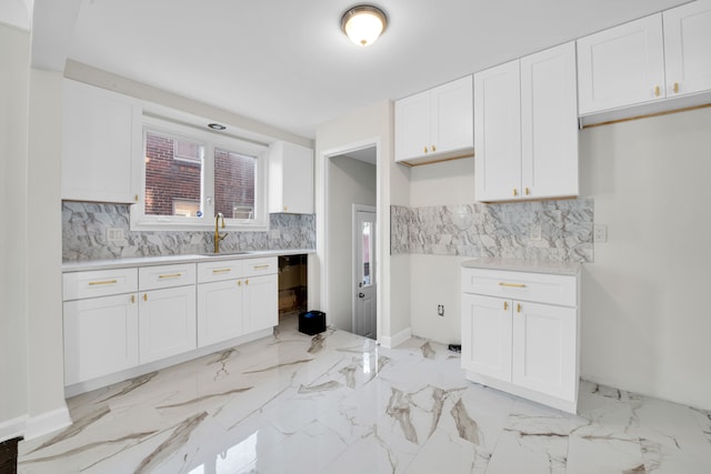 kitchen with white cabinetry and sink