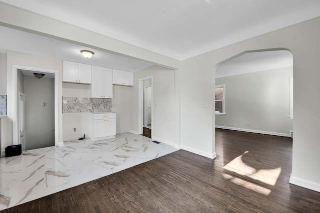 kitchen featuring decorative backsplash and white cabinetry