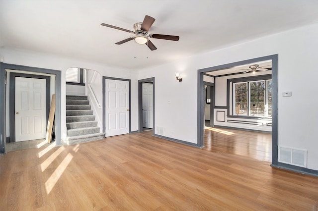 unfurnished living room featuring ceiling fan and light hardwood / wood-style floors