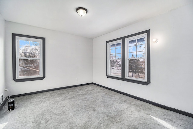 carpeted empty room with plenty of natural light